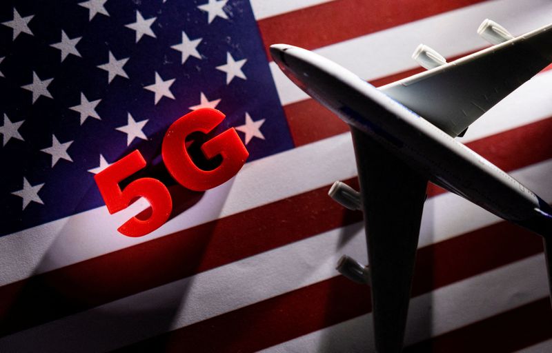 FILE PHOTO: 5G words and an airplane toy are placed