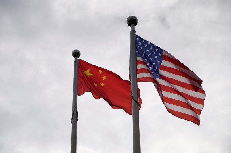 Chinese and U.S. flags flutter outside a company building in