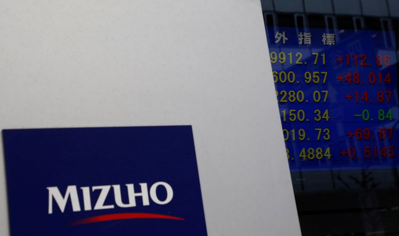 Mizuho Financial Group’s logo is seen next to an electronic