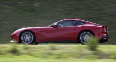 FILE PHOTO: A man drives a Ferrari luxury car in