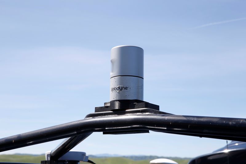 A Velodyne LiDAR sensor is seen mounted on a self-driving