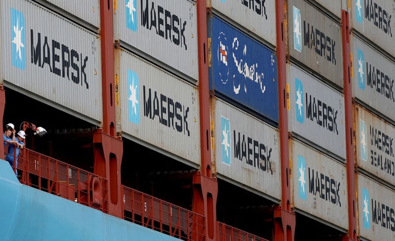 FILE PHOTO: Crew members look out from the MV Maersk