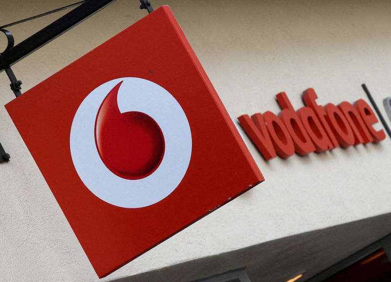 FILE PHOTO: Branding hangs outside a Vodafone shop in Oxford