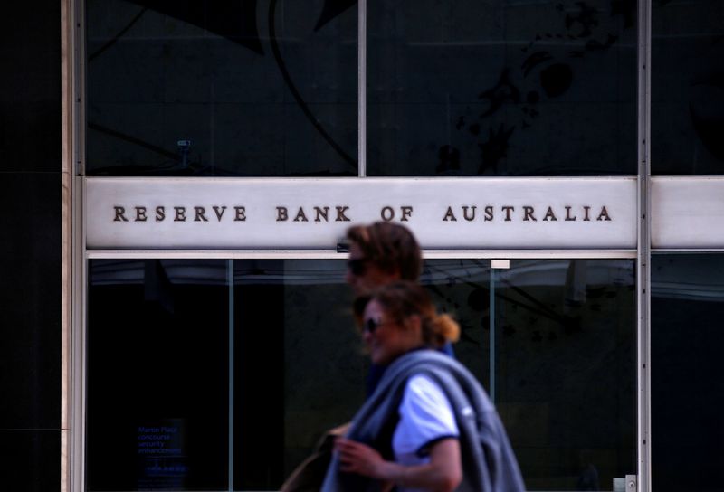Pedestrians walk past the main entrance to the Reserve Bank