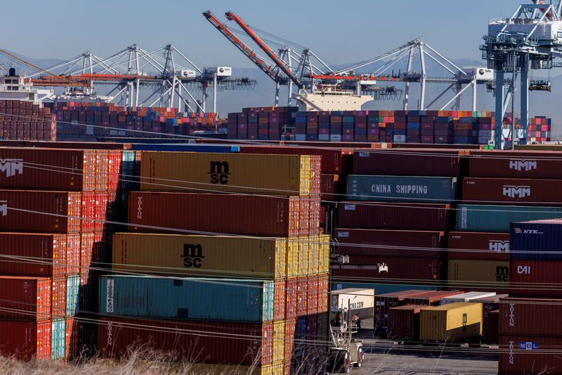 FILE PHOTO: Stacked containers are shown as ships unload their