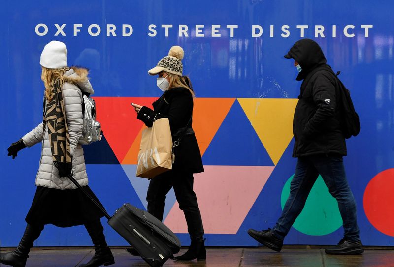 Shoppers walk on Oxford Street as rules on wearing face