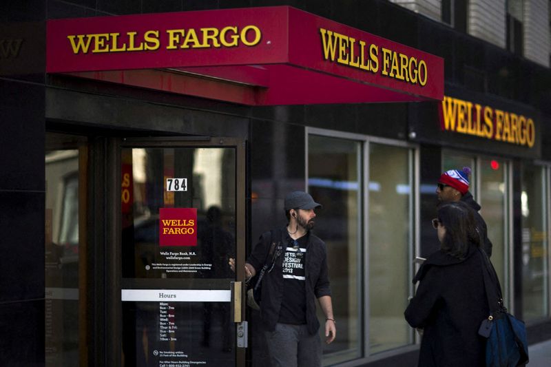 FILE PHOTO: People exit and enter Wells Fargo ATM in