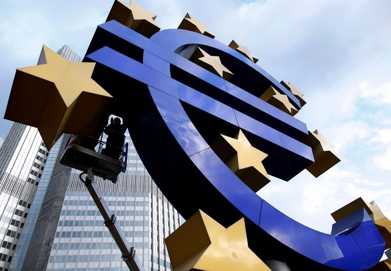 FILE PHOTO: Workers maintain the huge Euro logo in front