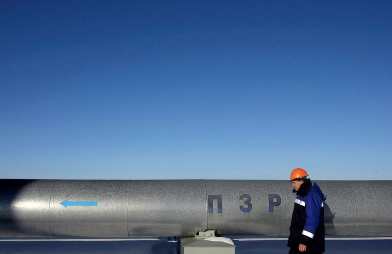 FILE PHOTO: Employee walks at Russian gas export monopoly Gazprom’s