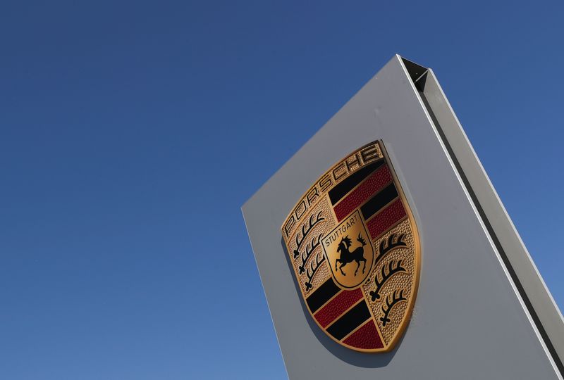 A logo of Porsche is seen outside a Porsche car