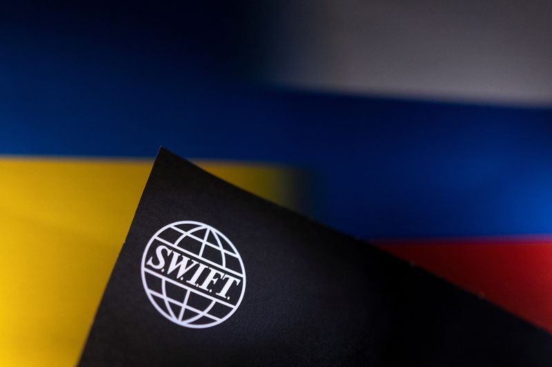 Illustration shows Swift logo placed on Ukrainian’s and Russian’s flag