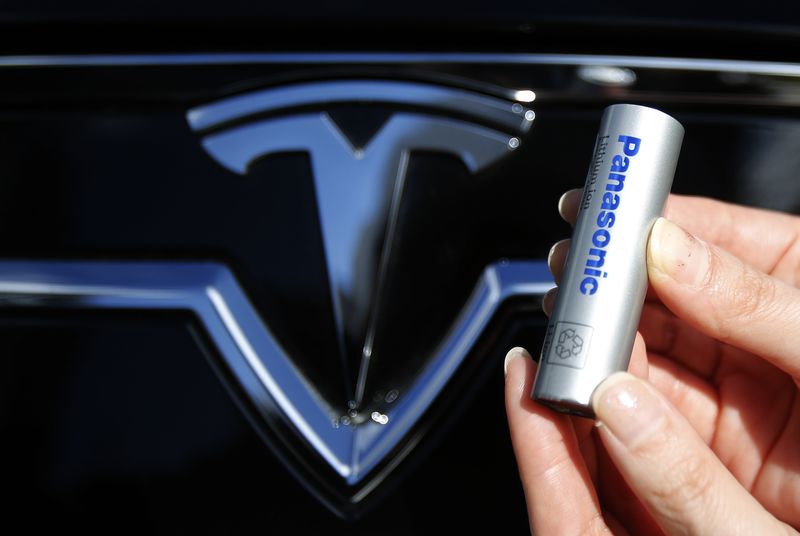 A Panasonic Corp’s lithium-ion battery is pictured with Tesla Motors