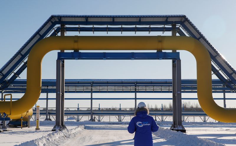 An employee walks past a part of Gazprom’s Power Of