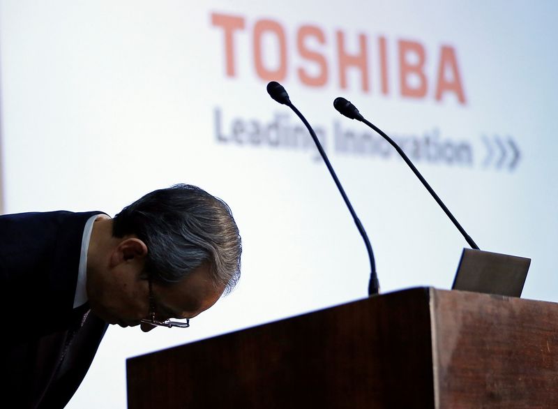 FILE PHOTO: Toshiba Corp CEO Satoshi Tsunakawa bows during a