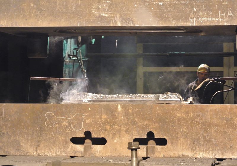 An employee works with a titanium ingot at the VSMPO-Avisma