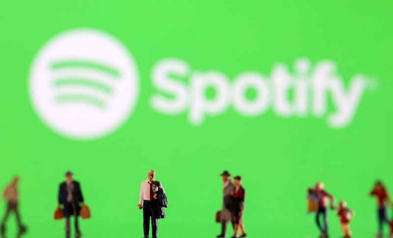 Illustration shows small figurines and displayed Spotify logo