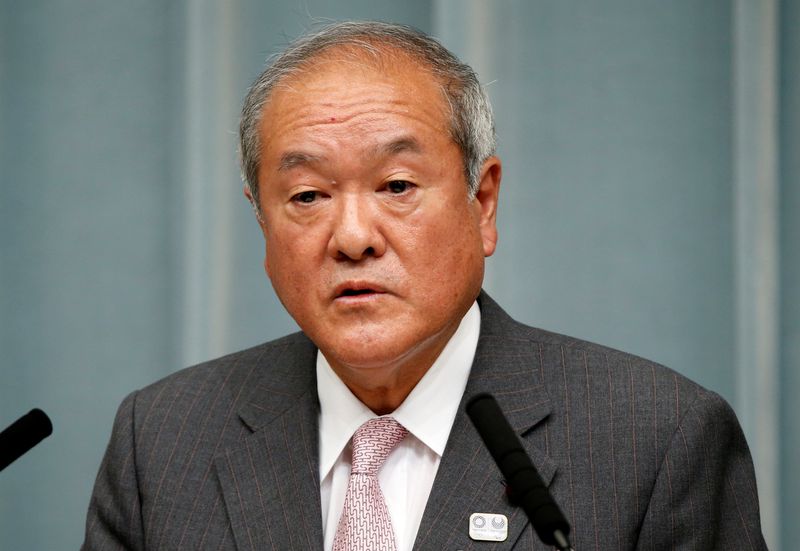 Japan’s Olympics Minister Shunichi Suzuki speaks at a news conference