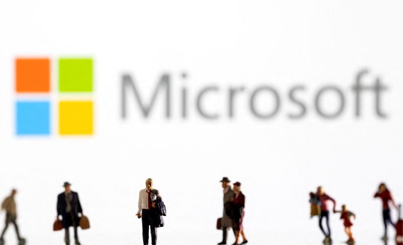 Illustration shows small figurines and displayed Microsoft logo