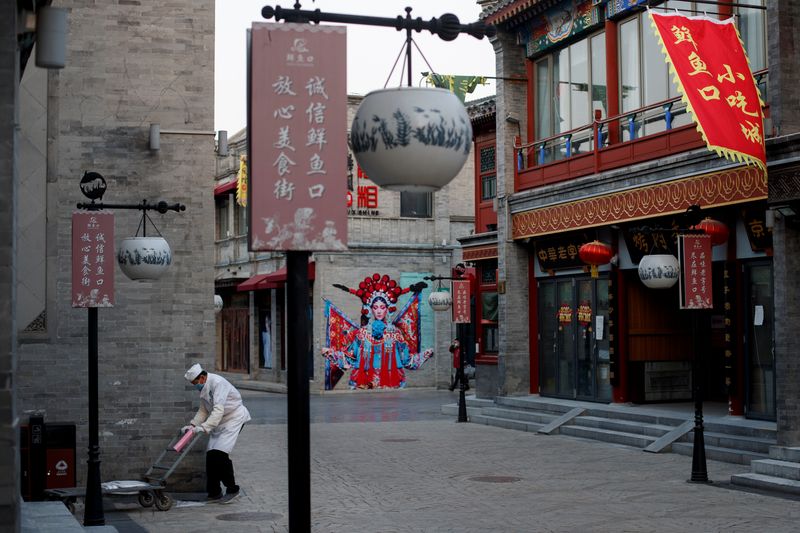 A kitchen worker pushes a trolley in the Qianmen district,