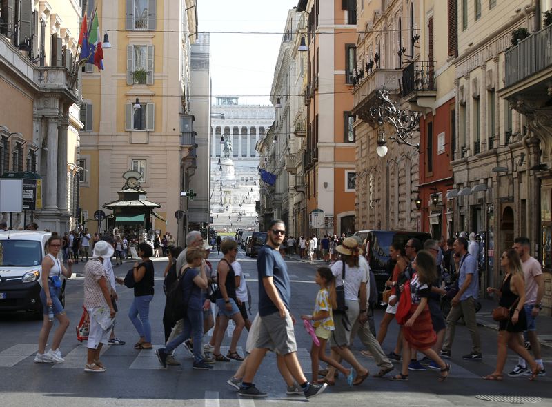 People cross the street in Rome
