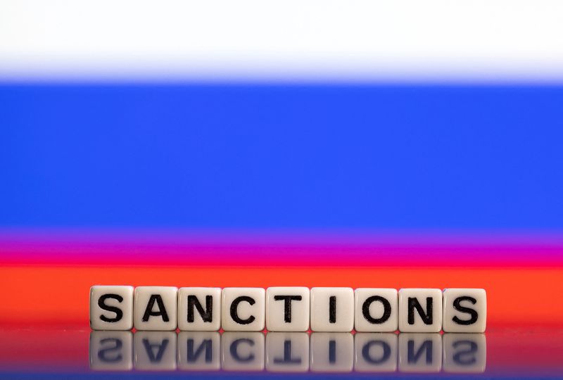 Illustration shows letters arranged to read “Sanctions” in front of
