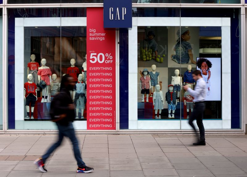 People walk past a Gap store on Oxford Street in