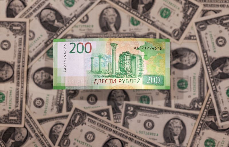 Illustration shows Russian Rouble banknote is placed on U.S. Dollar