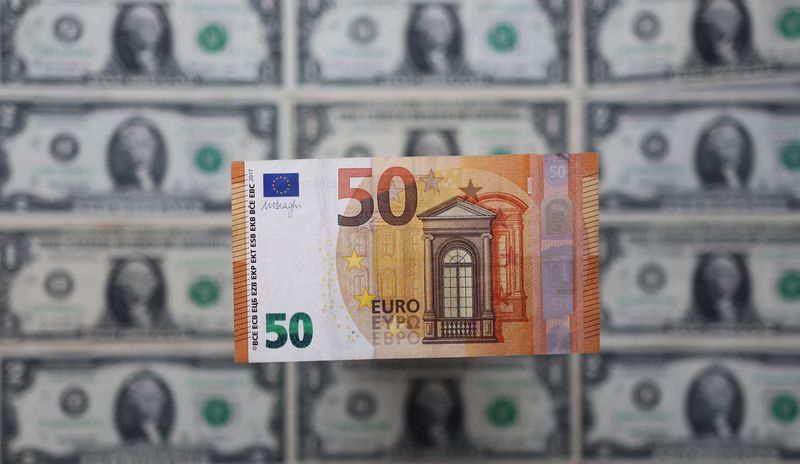 Illustration shows Euro banknote placed on U.S. Dollar banknotes