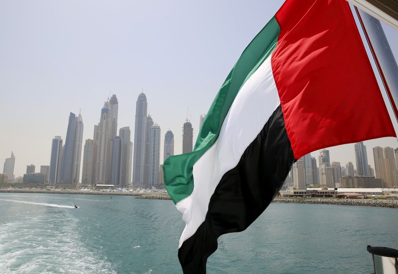 FILE PHOTO: UAE flag flies over a boat at Dubai