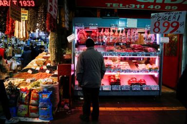 FILE PHOTO: A man looks at a butcher shop window