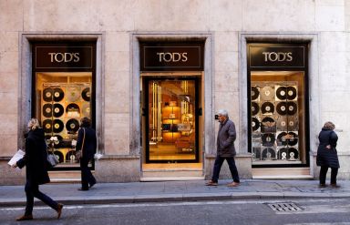 People walk past a Tod’s shop in downtown Rome
