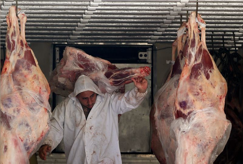 FILE PHOTO: A butcher unloads beef from a truck outside