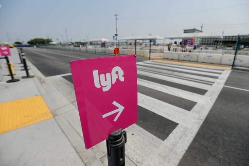 FILE PHOTO: Uber and Lyft drivers demonstrate over basic employee