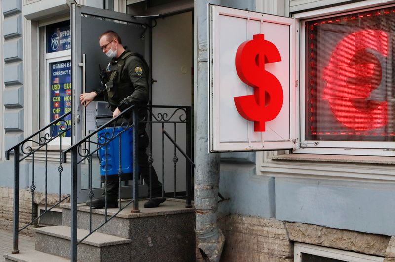 A cash-in-transit worker leaves a currency exchange office in Saint