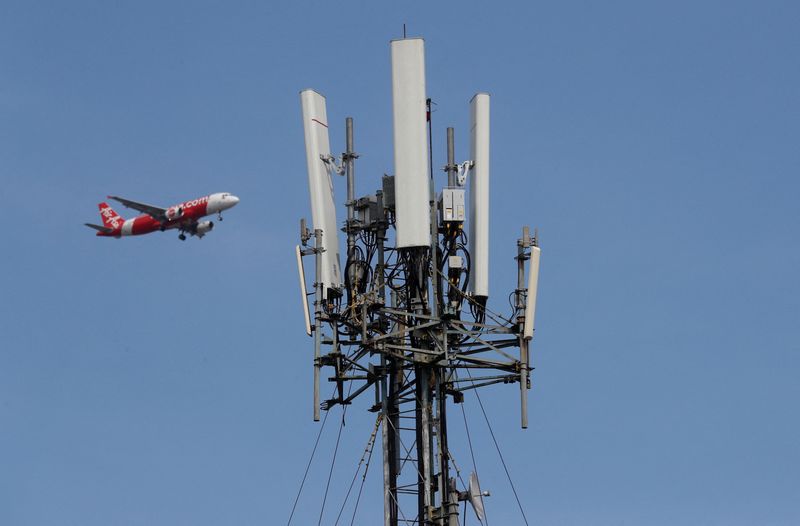 FILE PHOTO: A passenger plane flies past a Globe Telecoms