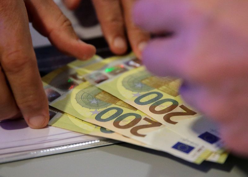 An Austrian central bank official takes new 200 euro banknotes