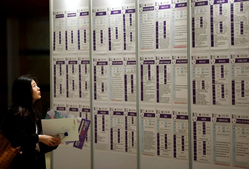 FILE PHOTO: A woman looks at recruiting information during a