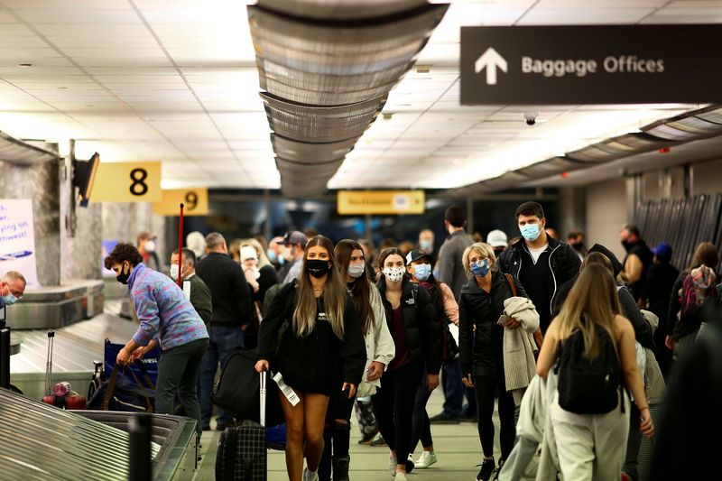 FILE PHOTO: Travelers reclaim luggage at Denver airport