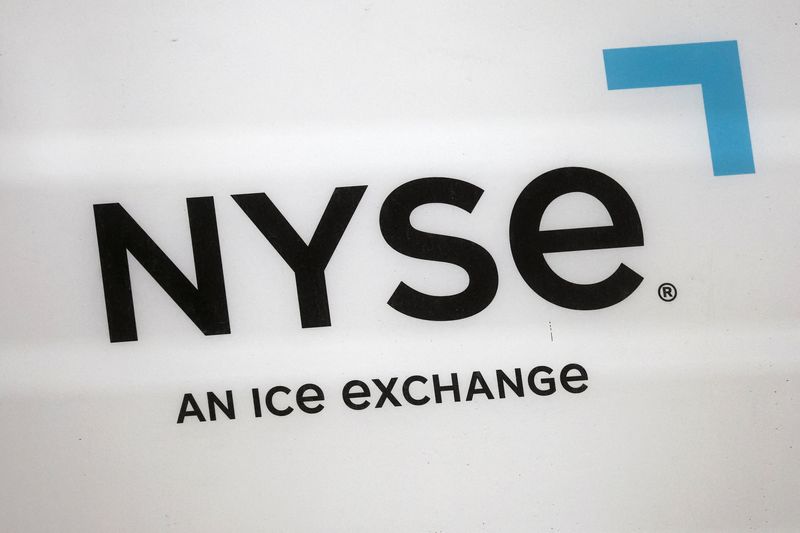 The logo for the NYSE displayed on Wall Street in