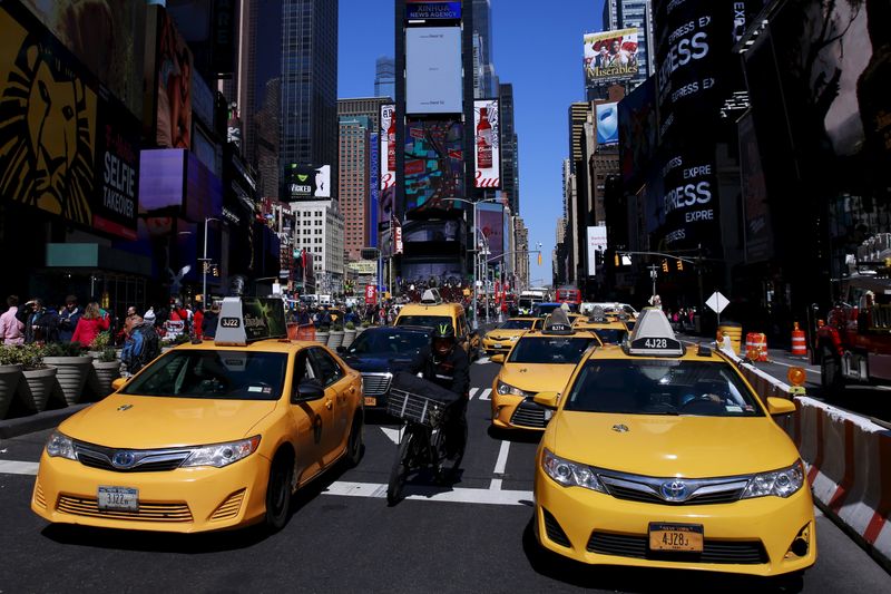 FILE PHOTO: New York City taxi cabs drive through Times