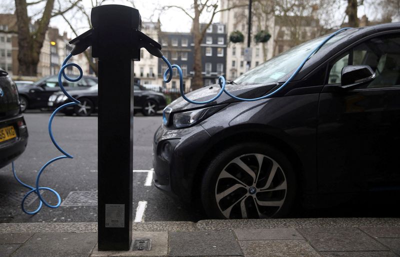 FILE PHOTO: Electric cars are plugged into a charging point
