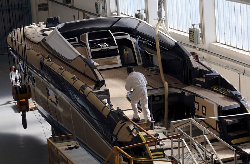 FILE PHOTO: Employees work on a yacht at the Ferretti