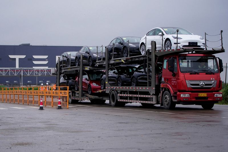 cFILE PHOTO: A truck transports new Tesla cars at its