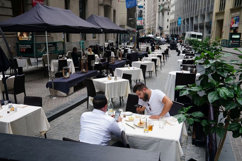 People eat at a mostly empty restaurant with tables on