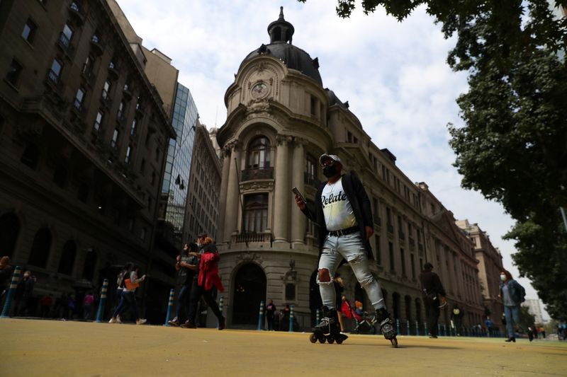 A man roller skates in front of Santiago’s stock exchange