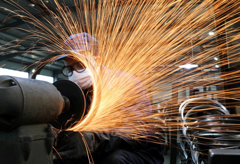 FILE PHOTO: Worker wearing a face mask works on a