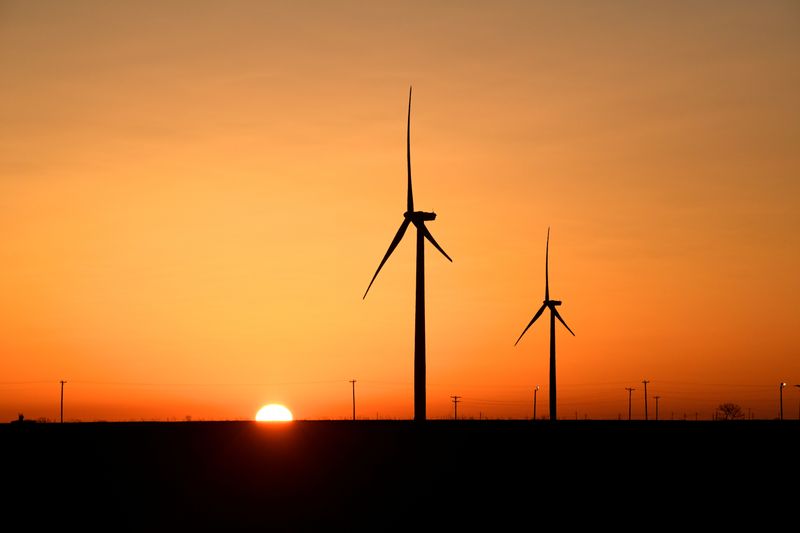 FILE PHOTO: Wind turbines operate at sunrise in Texas