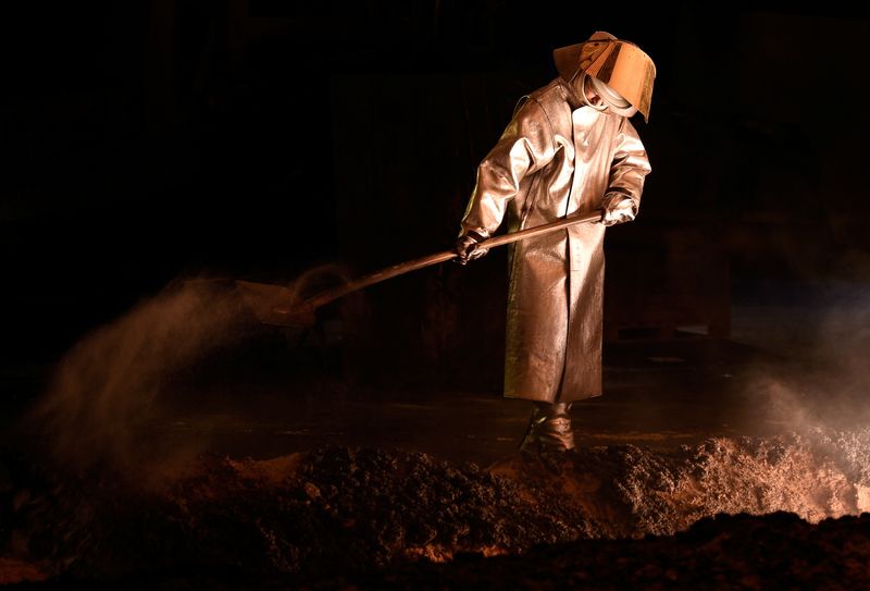 A steel-worker is pictured at a furnace at the plant