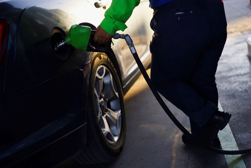 A worker fills a car belonging to a Texas resident,