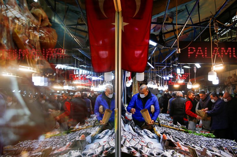 A vendor selling seafood serves customers in Ankara